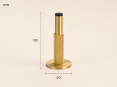 Detail van goudkleurige gekartelde messing deurstopper